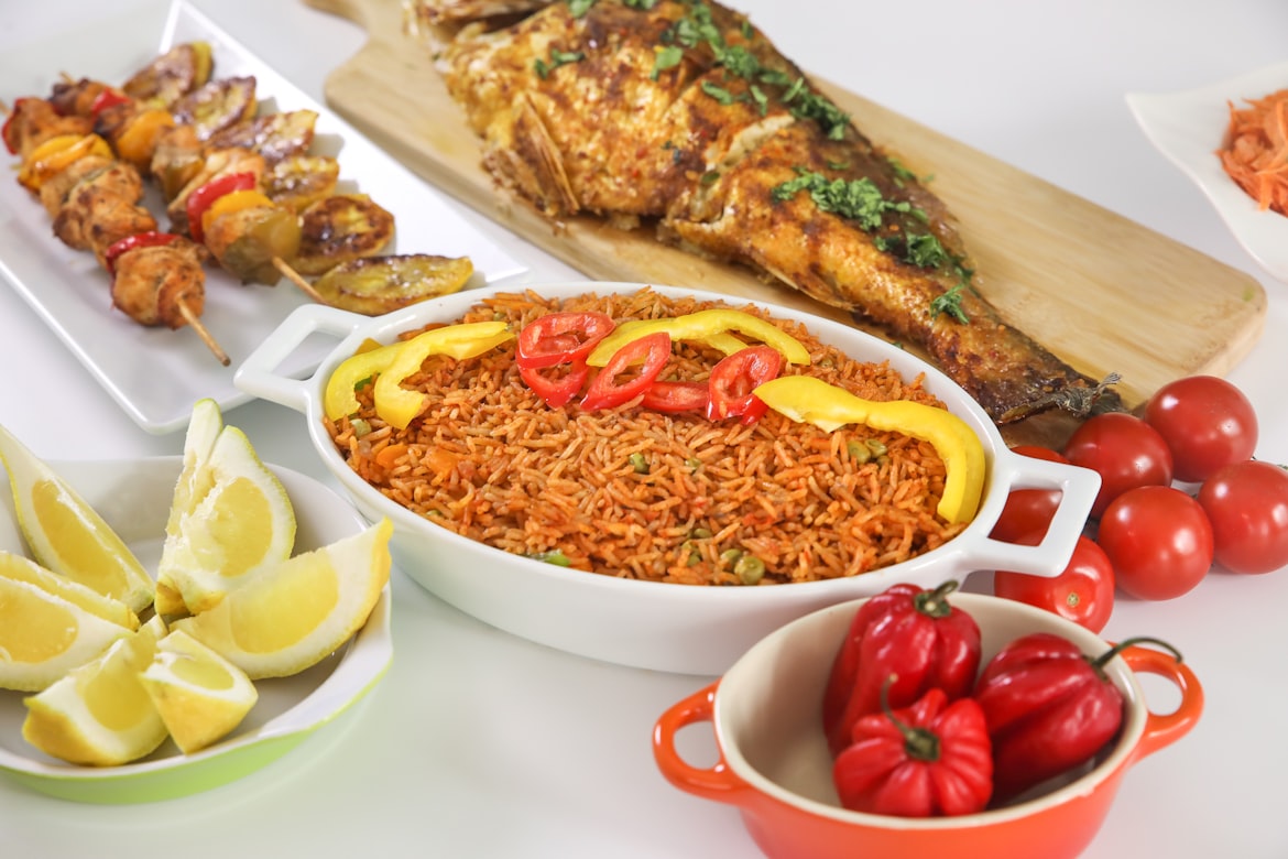 Jollof rice served hot with grilled fish and protein